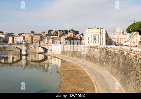 A street scene in Rome over river Tiber with historical buildings, bridge and Vatican in the back. Stock Photo