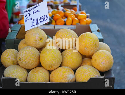 Muskmelons in crate at farmers market stall