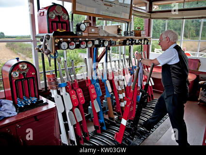 A Signalman at work at Wittersham Road Signalbox on the Kent and East Sussex Railway UK