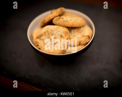 Delicious, yummy and luxurious home baked pistachio nut and chocolate chip shortbread cookies in a bowl Stock Photo