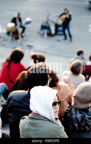 FLORENCE, ITALY - October 15, 2011: Street musician playing on a traditional acoustic guitar for the entertainment of tourists Sitting on the steps of Stock Photo