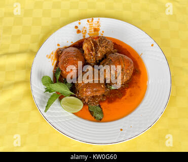 Lobster in tomato sauce served in a white dish and a slide of lemon Stock Photo