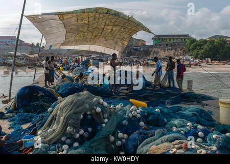 Fishermen repairing their nets on the pier, Jamestown Fishing Village, Jamestown, Accra, Ghana Stock Photo
