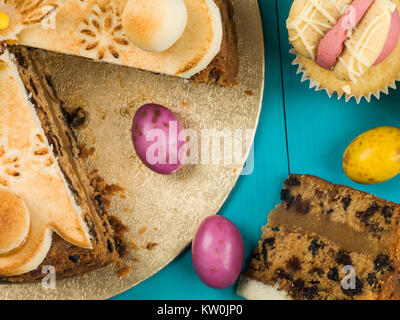 Traditional Easter Sunday Afternoon Tea and Cakes Against a Blue Background Stock Photo