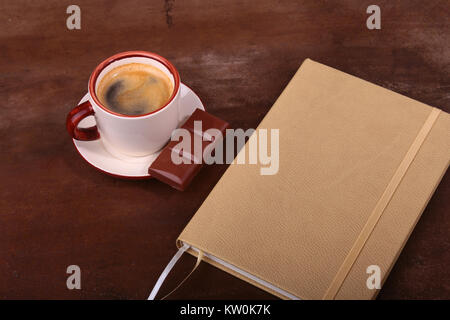 Notebook with pen and coffee cup on wooden background, business concept Stock Photo