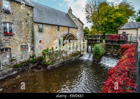 The water mill on the River Aure in the medieval town of Bayeux on the Normandy Coast of France, with bold autumn colors Stock Photo