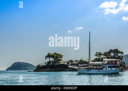 Ionian sea off the shores of zakynthos in the bay of Laganas is an old passenger ship moored on a small island near the island marathonisi Stock Photo