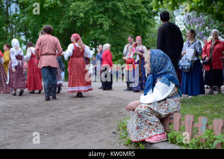 St. Petersburg, Russia - May 22, 2016: The girl in a national suit looks at dancing. An annual Nikolsky festival of folk art in St. Petersburg. Stock Photo