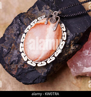 Stone bead necklace pendant on natural background Stock Photo