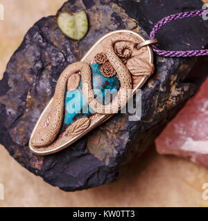 Stone bead necklace pendant on natural background Stock Photo