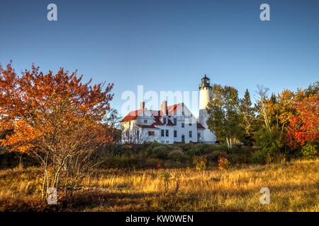 Michigan Autumn Lighthouse. The Point Iroquois Lighthouse with autumn foliage on Lake Superior in the Hiawatha National Forest of the Upper Peninsula Stock Photo