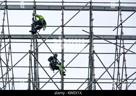 Scaffolders at work, building a large scaffolding, work at high altitude, Stock Photo