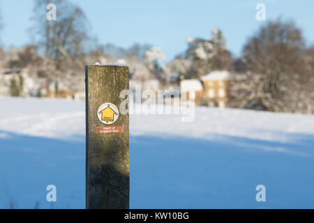 Heart of england way footpath sign in the snow. Bourton on the hill, Cotswolds, Gloucestershire, England. Stock Photo