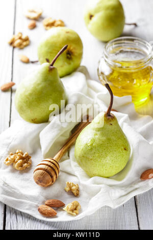 Tasty pears with honey and nuts on wooden table Stock Photo