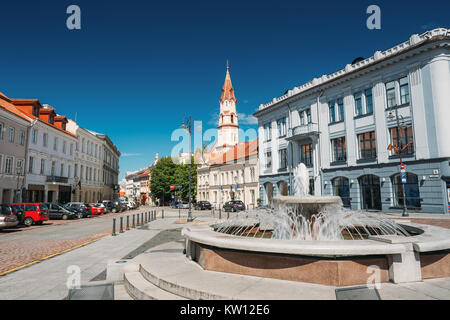 Vilnius, Lithuania. Town Hall Square Fountain In Rotuses Square In Old Town. St. Nicholas Church In Sunny Summer Day. Popular Touristic Place Stock Photo