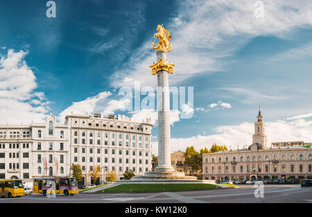 Tbilisi, Georgia. Liberty Monument Depicting St George Slaying The Dragon And Tbilisi City Hall In Freedom Square In City Center. Famous Landmark Stock Photo