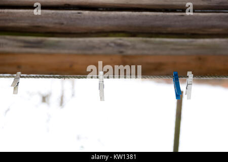 Old wooden clothespins on a rope Stock Photo