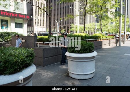 A counter-terrorism officer of the New York Police Department (NYPD) stand watchfully near the Manhattan headquarters of JP Morgan Chase, Manhattan, New York City, New York, July, 2016. Stock Photo