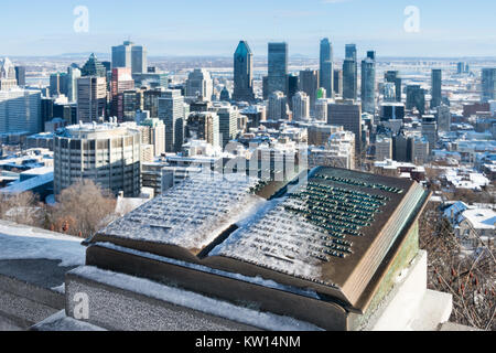 Montreal, CA - 26 December 2017: Downtown Montreal and Plaque of Jacques Cartier located at the summit of the Mont Royal, in winter. Stock Photo