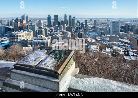 Montreal, CA - 26 December 2017: Downtown Montreal and Plaque of Jacques Cartier located at the summit of the Mont Royal, in winter. Stock Photo