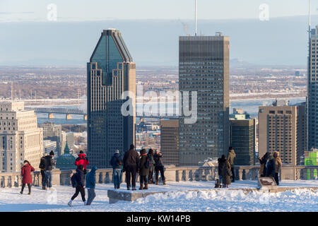 Montreal, CA - 26 December 2017: Tourists looking at Montreal Skyline from Kondiaronk belvedere in winter. Stock Photo