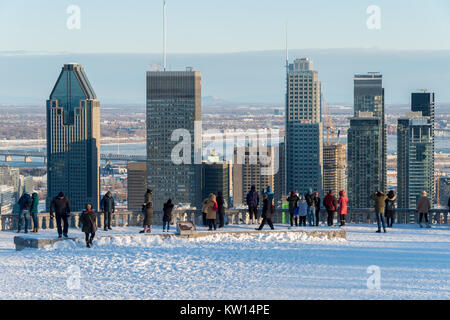 Montreal, CA - 26 December 2017: Tourists looking at Montreal Skyline from Kondiaronk belvedere in winter. Stock Photo