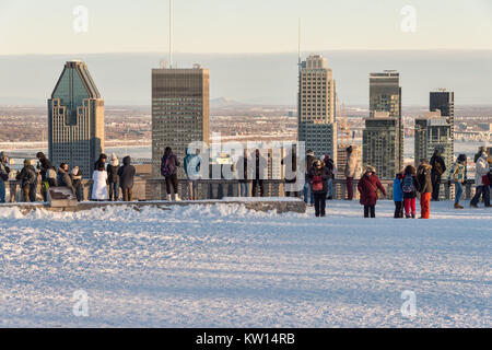 Montreal, CA - 26 December 2017: Tourists looking at Montreal Skyline from Kondiaronk belvedere in winter. Stock Photo