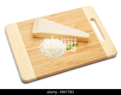 a piece of Parmesan and grated cheese on cutting board white background Stock Photo