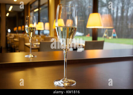 Glass of champagne on the table in the restaurant. Stock Photo