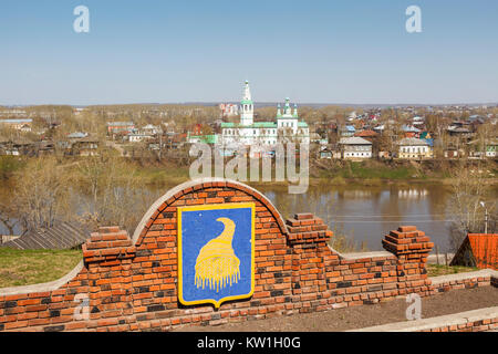 Town crest and view over the Kungurka River to a Russian Orthodox church with green roof and blue domes in Kungur, in southeast of Perm Krai, Russia Stock Photo