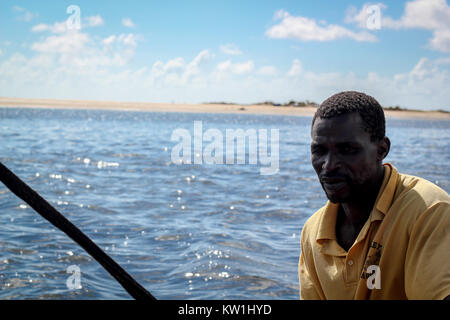 Mozambican fisherman in traditional sailboat in Tofo Beach near Maputo. Stock Photo