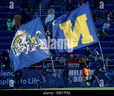 Annapolis, MD, USA. 28th Dec, 2017. Navy Cheerleaders carry their flags after the first touchdown during the Military Bowl between the University of Virginia Cavaliers and the United States Naval Academy Midshipmen at Navy Marine Corps Memorial Stadium in Annapolis, MD. Justin Cooper/CSM/Alamy Live News Stock Photo