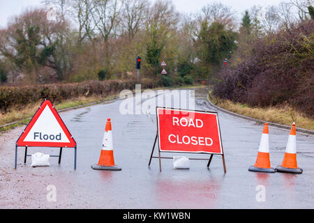 Northamptonshire, 29th December 2017, Weather. The river Nene overflowing on Station rd by White Mills Mariana, between Earls Barton and Grendon caused by the heavy overnight rain, road closed signs. Credit: Keith J Smith./Alamy Live News Stock Photo