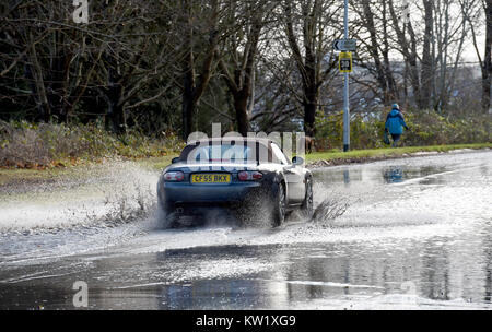 Lewes Sussex, UK. 29th Dec, 2017. Traffic drives through floodwater on the A275 in Lewes today after heavy rain . Parts of Britain are still struggling with snow and icy conditions but in the south temperatures are rising Credit: Simon Dack/Alamy Live News Stock Photo