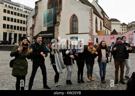 Basel, Switzerland. 29th December 2017. Young pilgrims sing and dance in front of the former Barfüsserkirche, now the Museum of History. unity also held a press conference with some informations about the meeting. Credit: Michael Debets/Alamy Live News Stock Photo