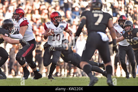 December 23, 2017 - San Diego State quarterback Christian Chapman (10) tries to break free of an Army defender during the second quarter of a NCAA college football game in the Lockheed Martin Armed Forces Bowl at Amon G. Carter Stadium in Fort Worth, Texas. Army won 42-35. Austin McAfee/CSM Stock Photo
