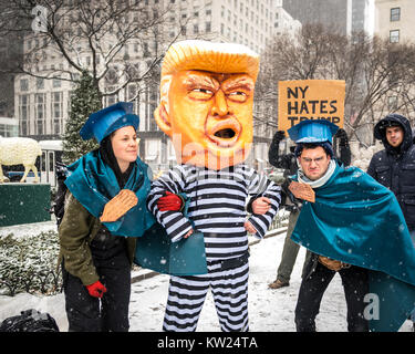 New York, USA, 30 Dec 2017.  Protesters representing New York policemen pretend to detain another demonstrator wearing a mask mocking a chained US President Donald Trump on a jail uniform, as they perform next to New York city's Plaza Hotel .  Demonstrators braved a snowstorm to demand Trump's impeachment. Photo by Enrique Shore/Alamy Live News Stock Photo