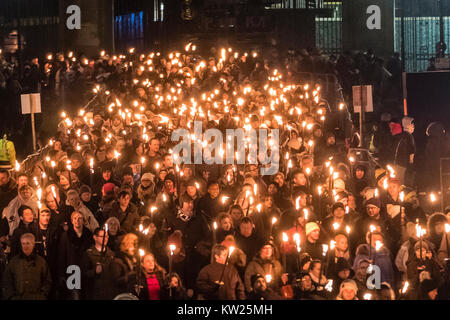 Edinburgh, Scotland,United Kingdom. 30 December, 2017.  Torchlight Procession which forms one part of Edinburgh's Hogmanay celebrations. pIctured; Procession passes in front of the Scottish Parliament building. Credit: Iain Masterton/Alamy Live News Stock Photo