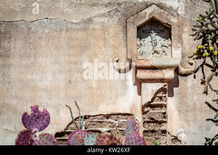 A Station of the Cross in the mortuary chapel courtyard of mission San Xavier del Bac near Tucson, Arizona. Stock Photo