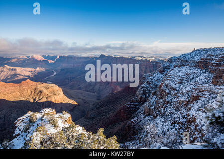 The Wintery rim of Navajo Point looks east past the Desert View Watchtower and over the Grand Canyon at sunrise. Stock Photo