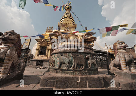 Tibetan stupa of Swayambudnath, the swept top of the structure, in the foreground a huge Buddhist vajra and stone sculptures of snow lions, Kathmandu, Stock Photo