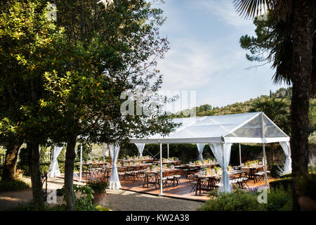 Tables sets for wedding or another catered event dinner. Courtyard of an Italian villa. Villa Bordoni Stock Photo