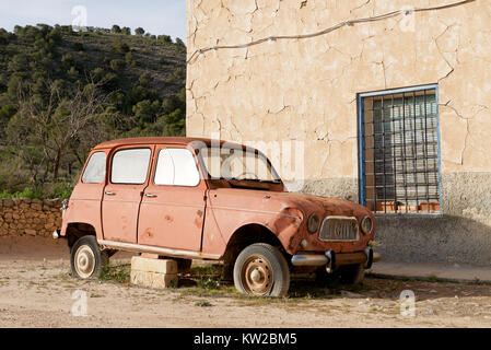 Old Renault 4L car on blocks in the countryside Stock Photo