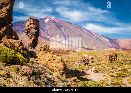 Famous Roque Cinchado unique rock formation with famous Pico del Teide mountain volcano summit in the background on a sunny day, Tenerife, Canaries Stock Photo