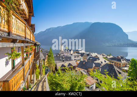 Classic aerial view of famous Hallstatt lakeside town in the Alps with idyllic pathway on a beautiful sunny day with blue sky in summer, Salzkammergut Stock Photo