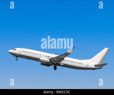 Plane at takeoff, the plane in the blue sky Stock Photo