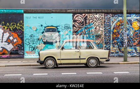 Famous Berliner Mauer (Berlin Wall) at East Side Gallery with an old Trabant, the most common vehicle used in East Germany, in front, Berlin Friedrich Stock Photo