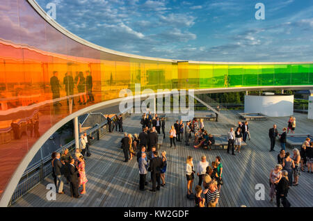 Conference participants mingle below the rainbow panorama at the roof of Aros Art Museum. The museum is the second most visited in Denmark. Stock Photo