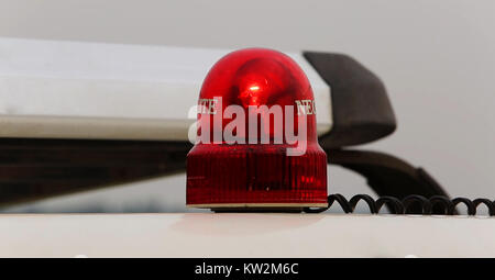 flashing red emergency light that is isolated on white Stock Photo