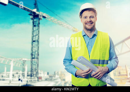construction project engineer with blueprints at building site Stock Photo